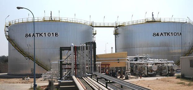 Large metal tanks in a factory
Description automatically generated