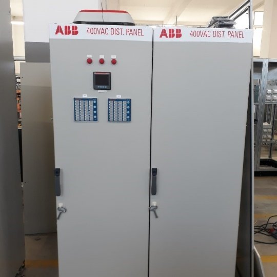 A large white cabinet with buttons and switches
Description automatically generated