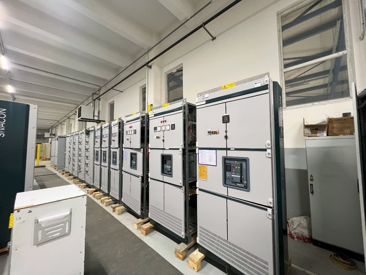 A row of white cabinets in a warehouse
Description automatically generated
